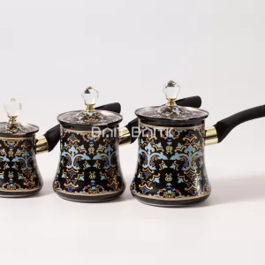 Row of three black Turkish coffee pots in different sizes